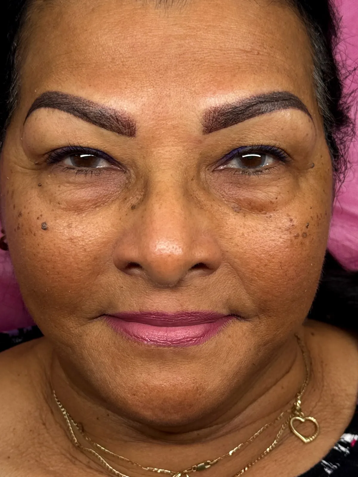 The same brows after combo brows — hair strokes with soft shading in a warm brown